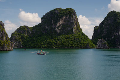 Scenic view of sea and mountains against sky