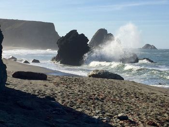 Scenic view of beach against clear sky