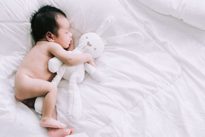 High angle view of baby sleeping on bed