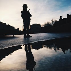 Reflection of building in water at sunset