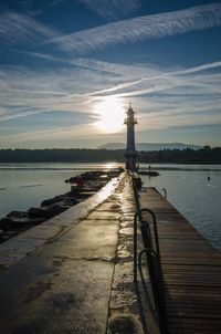 Pier over sea against sky during sunset