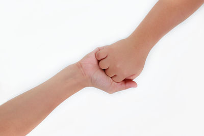 Close-up of hands over white background