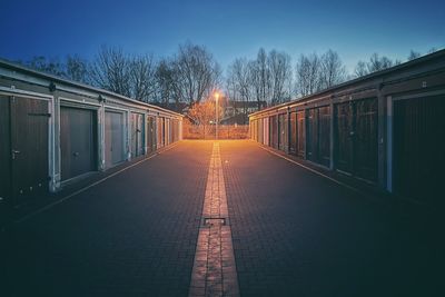 Illuminated train against sky at dusk