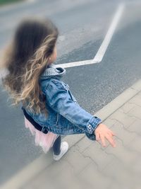 High angle view of woman on road in city