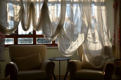 Curtain hanging over sofa at home