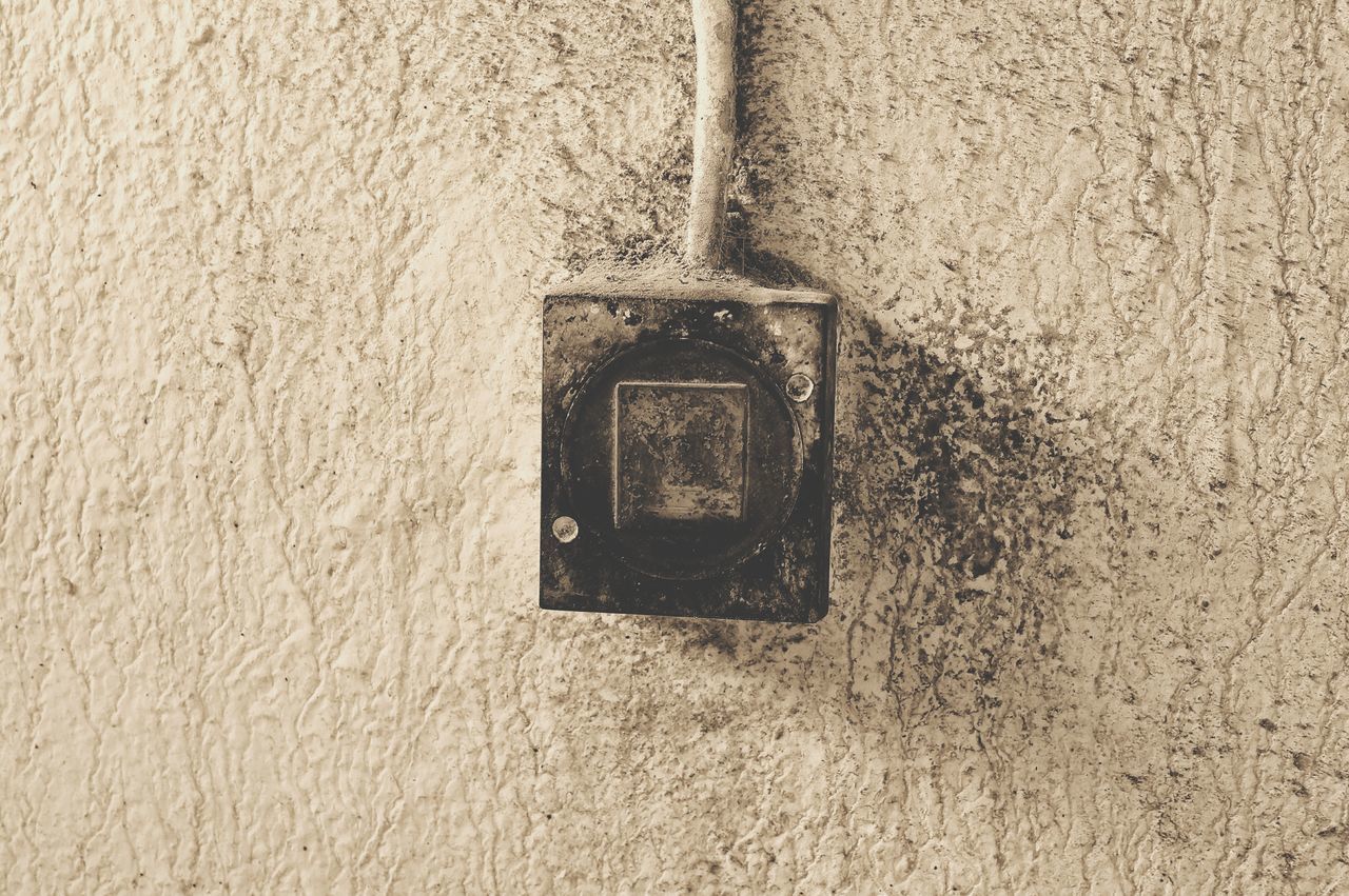 CLOSE-UP OF ELECTRIC LIGHT ON WALL