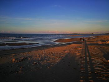 Scenic view of beach against sky during sunset