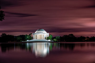 Reflection of building in lake at sunset