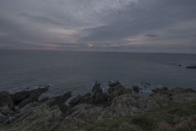 Scenic view of sea against cloudy sky