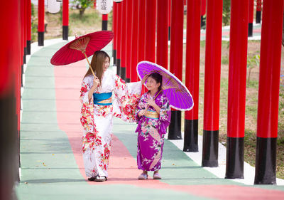 Full length of woman holding umbrella