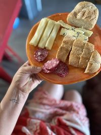 Cropped hand of woman holding food