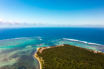 Wind surfers, beach and coral reefs from high angle view in le morne beach, mauritius