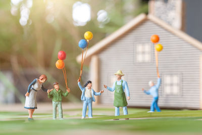 Rear view of people playing with balloons