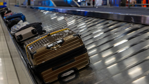 High angle view of suitcases on conveyor belt