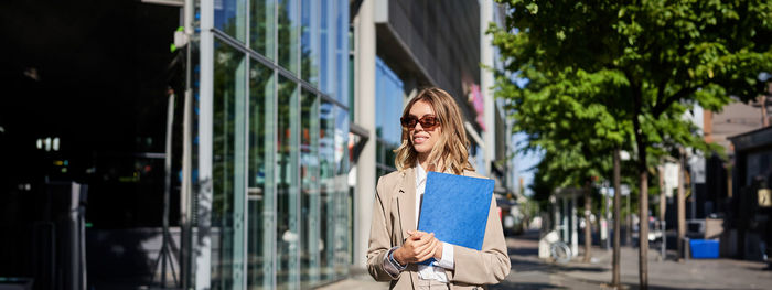 Rear view of woman standing in city