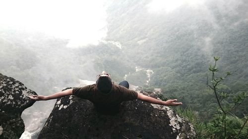 Woman sitting on rock