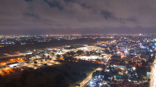 High angle view of illuminated buildings in city at night accra