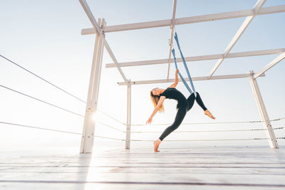 Low section of woman exercising on field