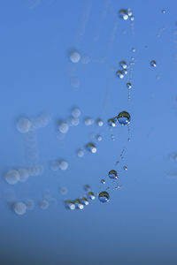 Close-up of bubbles against blue water