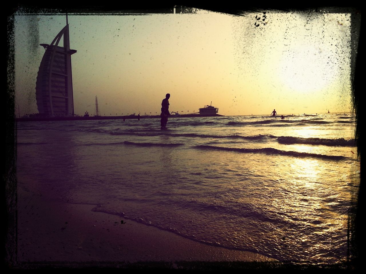 water, sea, transfer print, beach, auto post production filter, horizon over water, shore, lifestyles, silhouette, leisure activity, sunset, wave, men, sand, sky, standing, nature, unrecognizable person