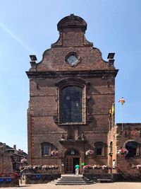 Facade of bell tower against sky