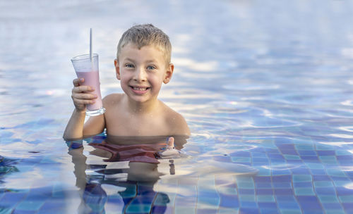 Portrait of boy swimming in pool