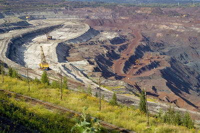 Concept of mineral development - panorama of operating ore mine, top view.