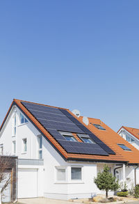 Germany, north rhine-westphalia, solar panels on tiled roofs of modern suburban house
