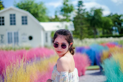 Portrait of girl wearing sunglasses standing outdoors