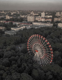 High angle view of ferris wheel in city against sky