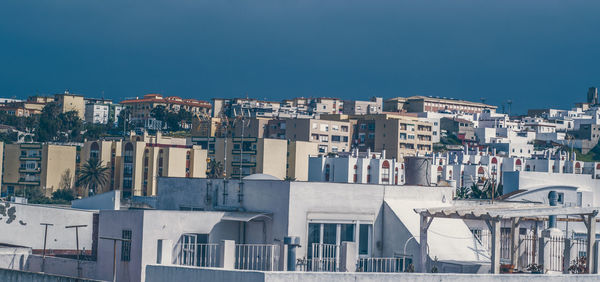 View of cityscape against clear blue sky