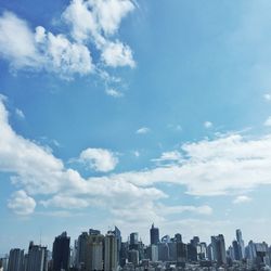 Skyscrapers against cloudy sky