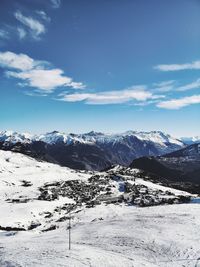 Scenic view of snowcapped mountains against sky