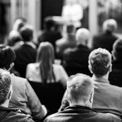 Unrecognizable group of people sitting, attending a seminar or a business presentation