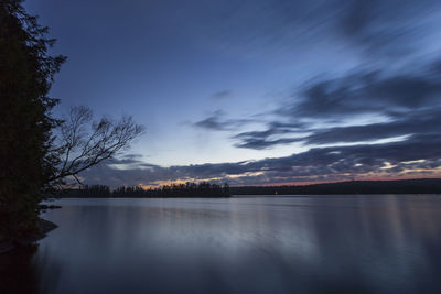 Scenic view of lake against sky at sunset