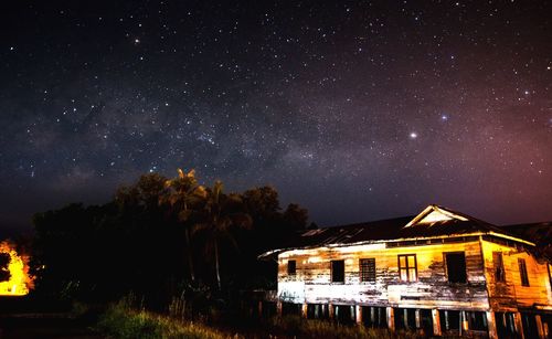 Illuminated building against sky at night