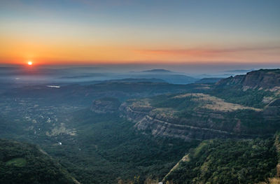 Scenic view of landscape against sky during sunset