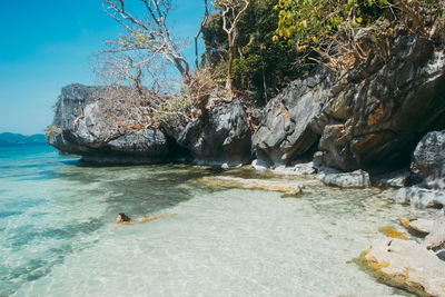 Woman swimming in sea on sunny day