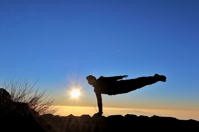 Low angle view of silhouette people at sunset