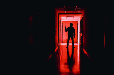 Silhouette criminal standing in corridor of building