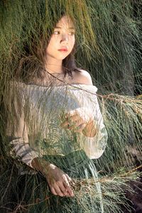 Portrait of woman on grass in field