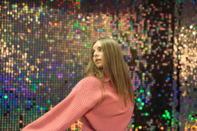 Portrait of young woman standing at home