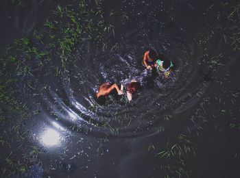 HIGH ANGLE VIEW OF PEOPLE AT NIGHT