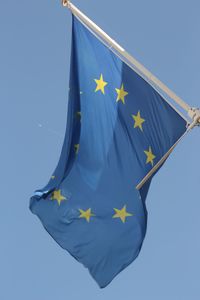 Low angle view of european union flag against clear blue sky