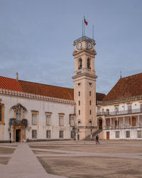 Clock tower in old town against sky