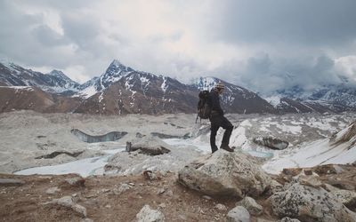 Full length of person on snowcapped mountain against sky