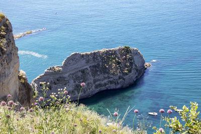 High angle view of rocks by sea