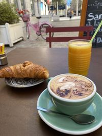 Croissant cappuccino orange juice pink bike at french street in nice france