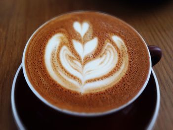 Close-up of cappuccino served on table