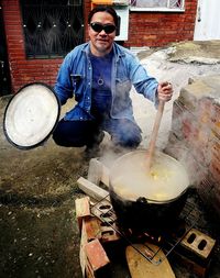 Full length of man preparing food in kitchen